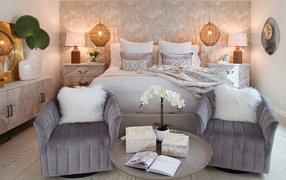 Bedroom interior with king size bed and two armchairs
