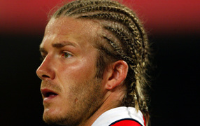 Football player David Beckham with pigtails on his head