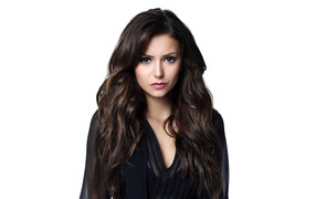 Long-haired girl actress Nina Dobrev on a white background
