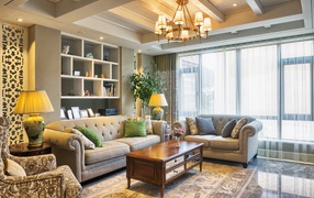 Много мягкой мебели в гостиной комнате с люстрой