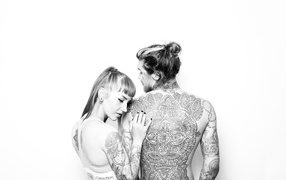 Man and girl with tattoos on the body on a white background