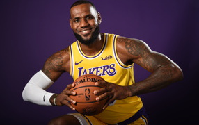 Smiling basketball player LeBron James with a ball
