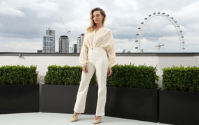 Stylish actress Margot Robbie in a white suit