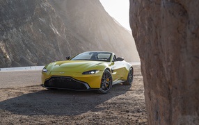 Yellow 2021 Aston Martin Vantage Roadster in the mountains