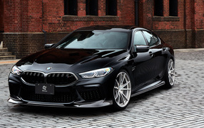 Expensive black BMW M8 car against the wall