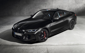 2020 BMW M4 Competition X Kith black car against a gray wall