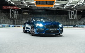 2020 BMW M8 Convertible with headlights on at the stadium