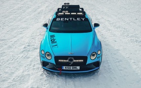 2020 blue Bentley Continental GT Ice Race stands on a snowy road