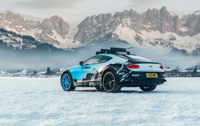 Car bentley continental gt, 2020 against the backdrop of snow-capped mountains