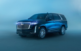 Черный Cadillac Escalade Luxury, 2021 года на сером фоне