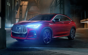 Красный автомобиль Infiniti QX55 AWD, 2022 года с включенными фарами