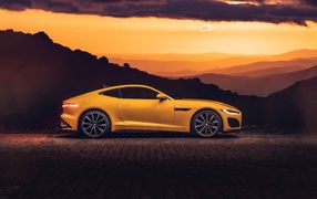 2020 yellow jaguar f type car at sunset