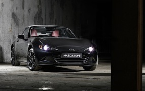 2020 black Mazda MX-5 Eunos Edition with headlights on