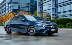 Blue car Mercedes-Benz AMG A 35, 2020 against the backdrop of the building