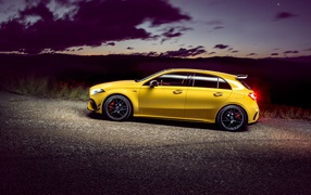 Yellow car Mercedes-AMG A 45 S, 2020 on the road at dusk