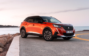 Red Peugeot 2008 GT 2019 off-road car by the ocean