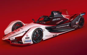 Гоночный автомобиль Porsche 99X Electric 2019 года на красном фоне
