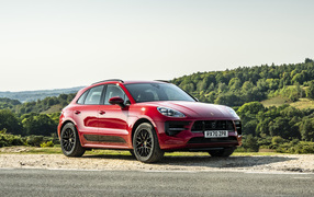 Красный автомобиль Porsche Macan GTS 2020  года в лучах солнца