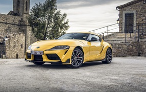Yellow Toyota GR Supra 2, 2020 at the old building