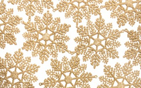 Golden snowflakes on a beige background