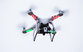 Quadrocopter with a video camera on a white background