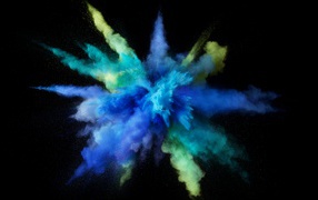 Взрыв сине-желтой краски на черном фоне