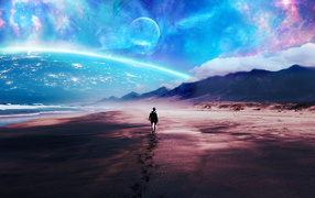 A man walks on the sand against a fantastic sky
