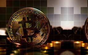 Bitcoin coins on a background in a cage