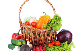 Basket of fresh vegetables on a white background