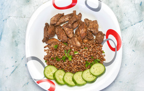 Buckwheat on a plate with meat and cucumbers