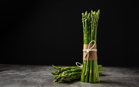 Green asparagus on black background