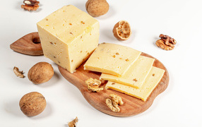 Hard cheese on a board with walnuts