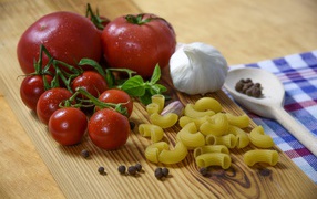 Pasta on the table with tomatoes and garlic