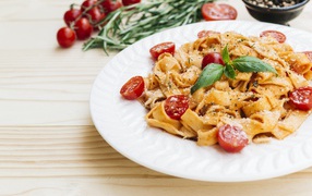 Pasta with cherry tomatoes on a white plate