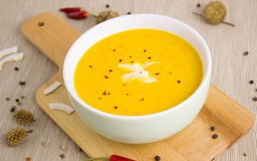 Pumpkin soup puree on a board in a white plate