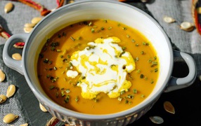 Pumpkin soup with sour cream in a saucepan