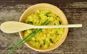 Risotto dish in wooden bowl with spoon