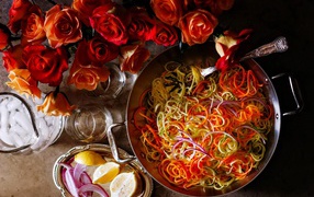 Salad of vegetables on a table with roses