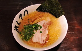 Суп с беконом и зеленью на столе 