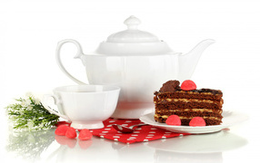 White cup of tea and teapot on the table with a piece of cake