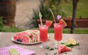 Куски арбуза на столе с коктейлем