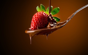 Красная клубника на ложке с молочным шоколадом