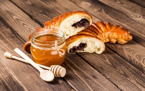Croissants on a table with honey