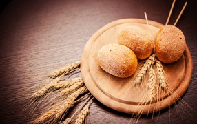 Fresh bread with wheat ears on chalkboard