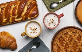 Fresh pastries and two mugs of milk on the table