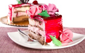 Кусок аппетитного торта декорирован розами из крема