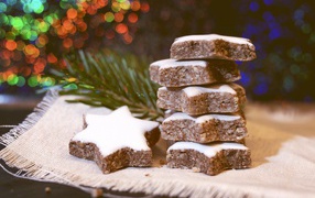 Печенье с глазурью на столе с еловой веткой 