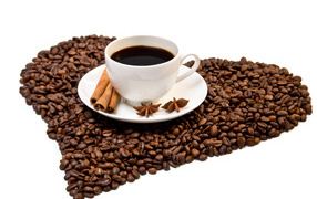 Белая чашка с корицей и бадьяном стоит на кофейных зернах на белом фоне