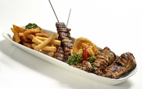 Мясо барбекю на тарелке с морепродуктами в кляре