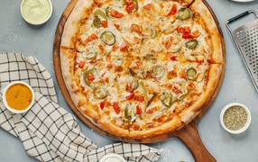 Appetizing pizza with vegetables and cheese on the board